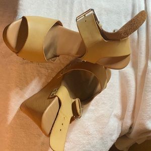 Tan wedge open toe with buckles around the ankles